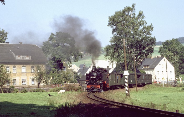 99 1785 mit P 23573 hinterm Bahnübergang in Neudorf, am 08.09.1989